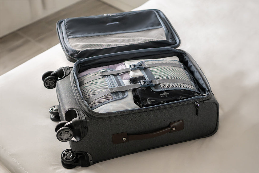 Travelpro cabin suitcase being packed with tie-down straps