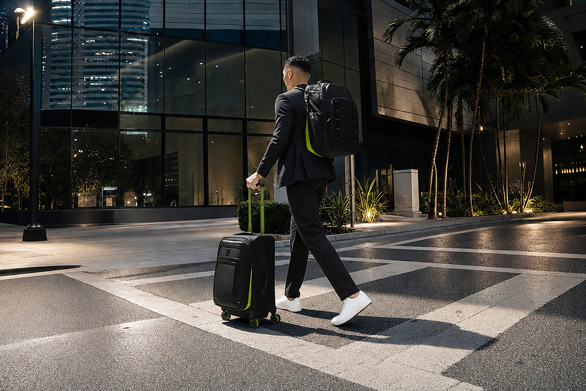 Man walking along a city street with Platinum Elite Neon Shadow cabin luggage
