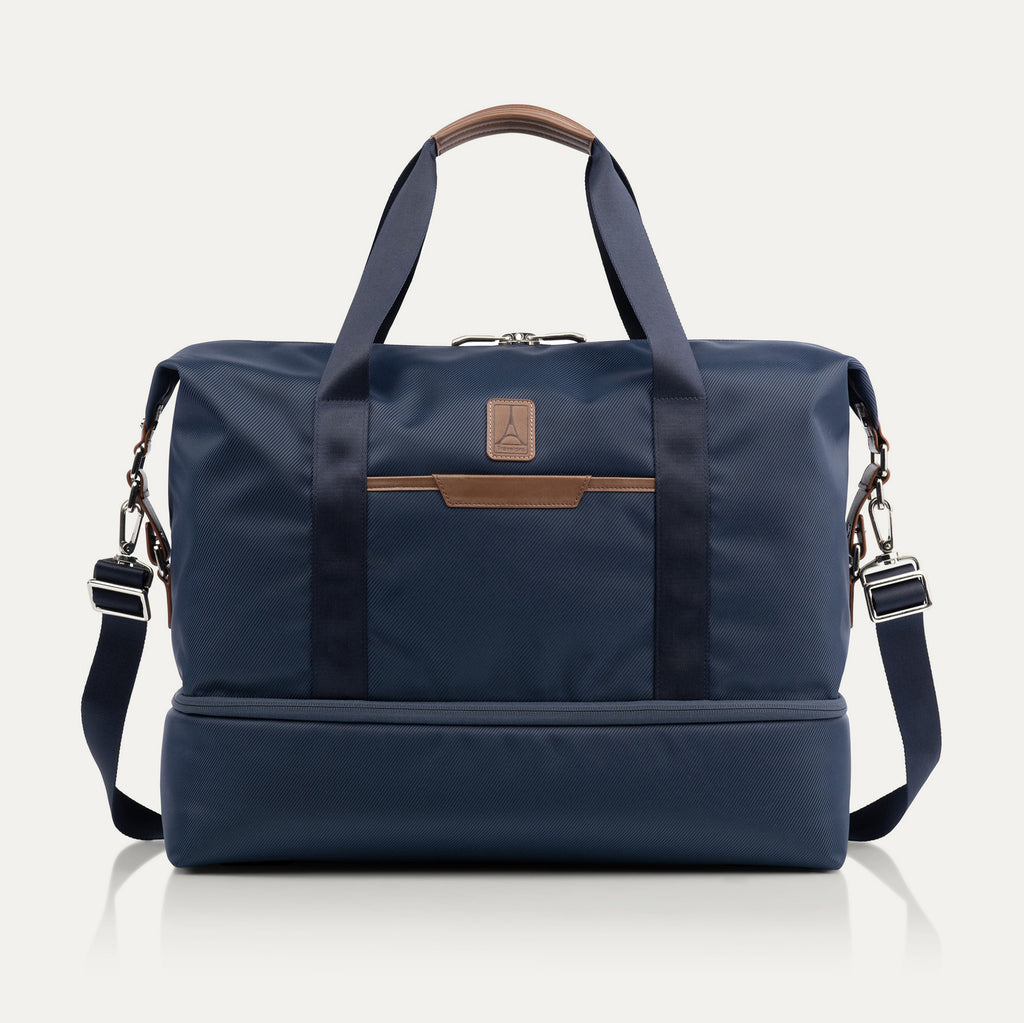 Travelpro x Travel + Leisure Drop-Bottom Weekender bag in Monaco Blue with black accents, featuring a spacious main compartment, zippered bottom section, and removable shoulder strap