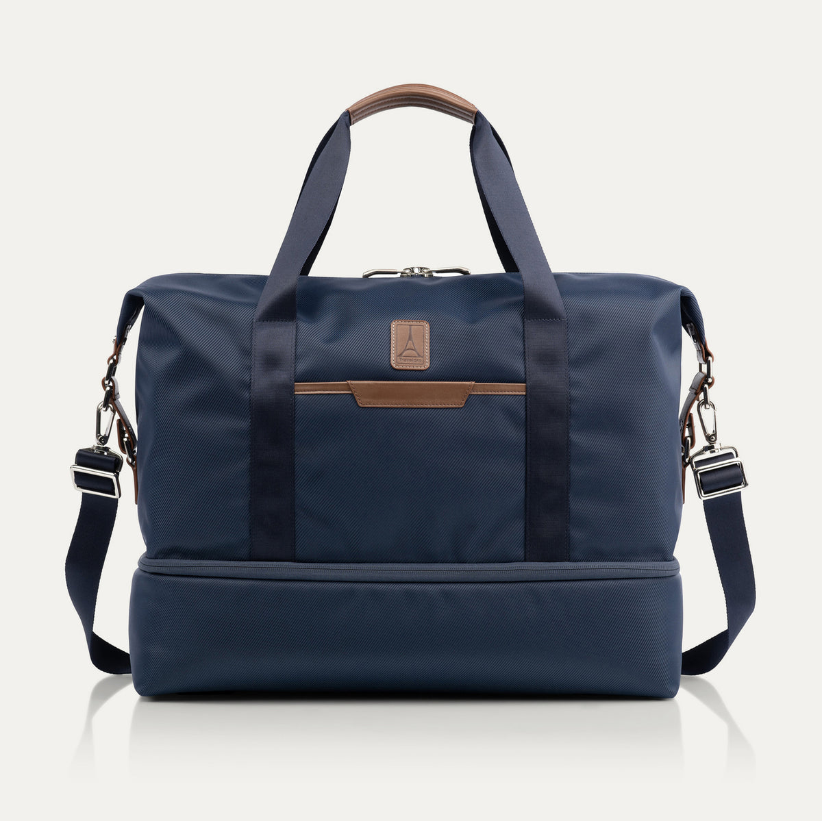 Travelpro x Travel + Leisure Drop-Bottom Weekender bag in Monaco Blue with black accents, featuring a spacious main compartment, zippered bottom section, and removable shoulder strap