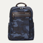 Travelpro Platinum® Elite Slim Backpack in blue camo, featuring durable fabric, brown leather trim, zippered front pocket, and padded laptop compartment