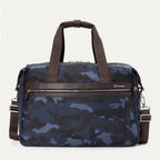 Travelpro Platinum® Elite Soft Duffel bag in blue camo, featuring durable fabric, brown leather accents, multiple zippered compartments, and adjustable shoulder strap.