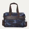 Travelpro Platinum® Elite Underseat Tote in blue camo, featuring durable fabric, brown leather accents, front zip pocket, and removable shoulder strap.