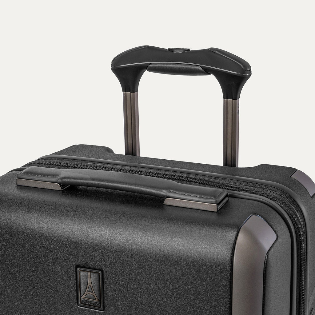 Close-up of the leather-wrapped top handle and PowerScope Lite extension handle on the Travelpro Platinum Reserve Compact Cabin Hardshell Spinner in Black Dust