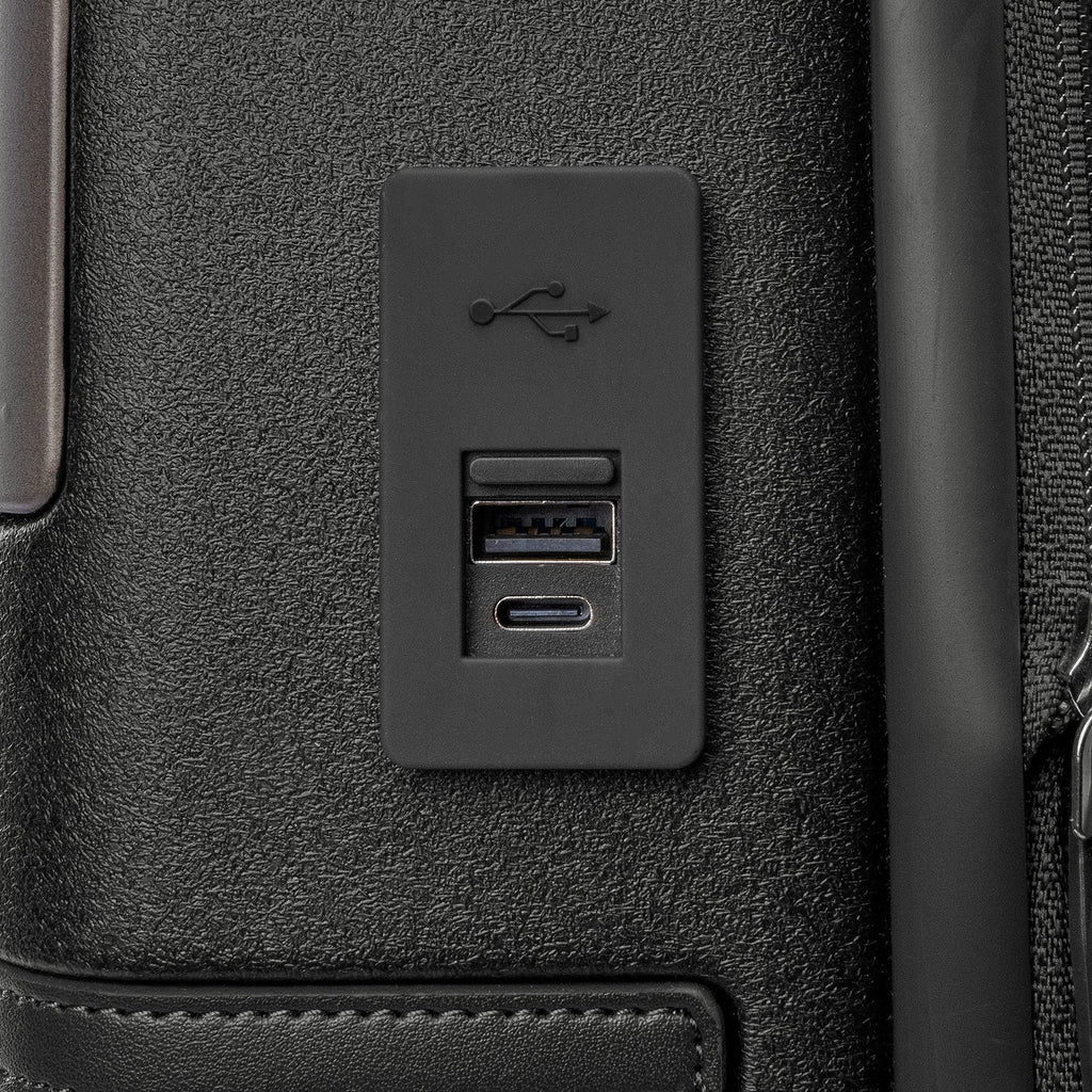 Close-up of the external USB-A and USB-C charging ports on the Travelpro Platinum Reserve Compact Cabin Hardshell Spinner in Black Dust