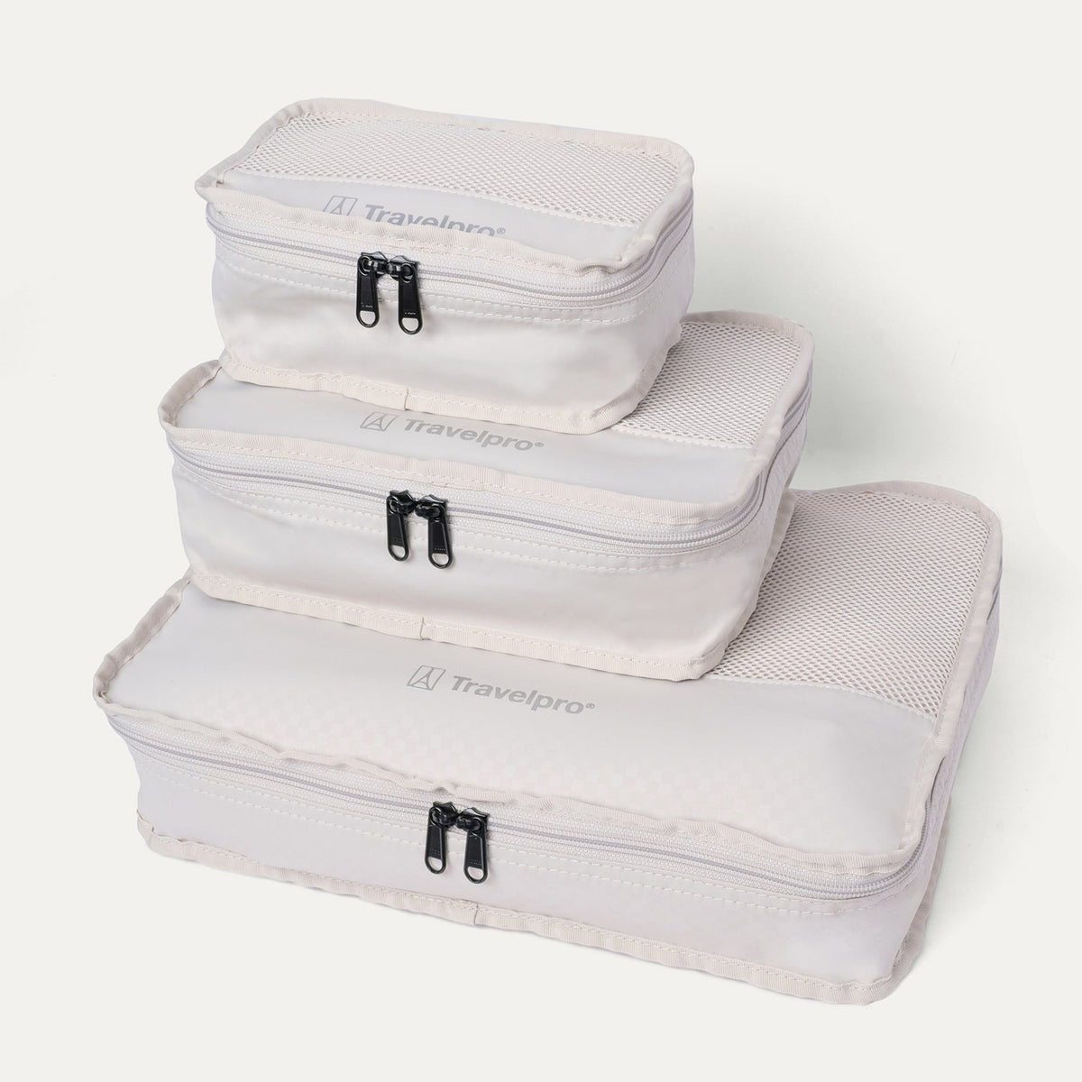 Packing cubes included with the Travelpro Platinum Reserve Compact Cabin Hardshell Spinner in Black Dust, stacked by size