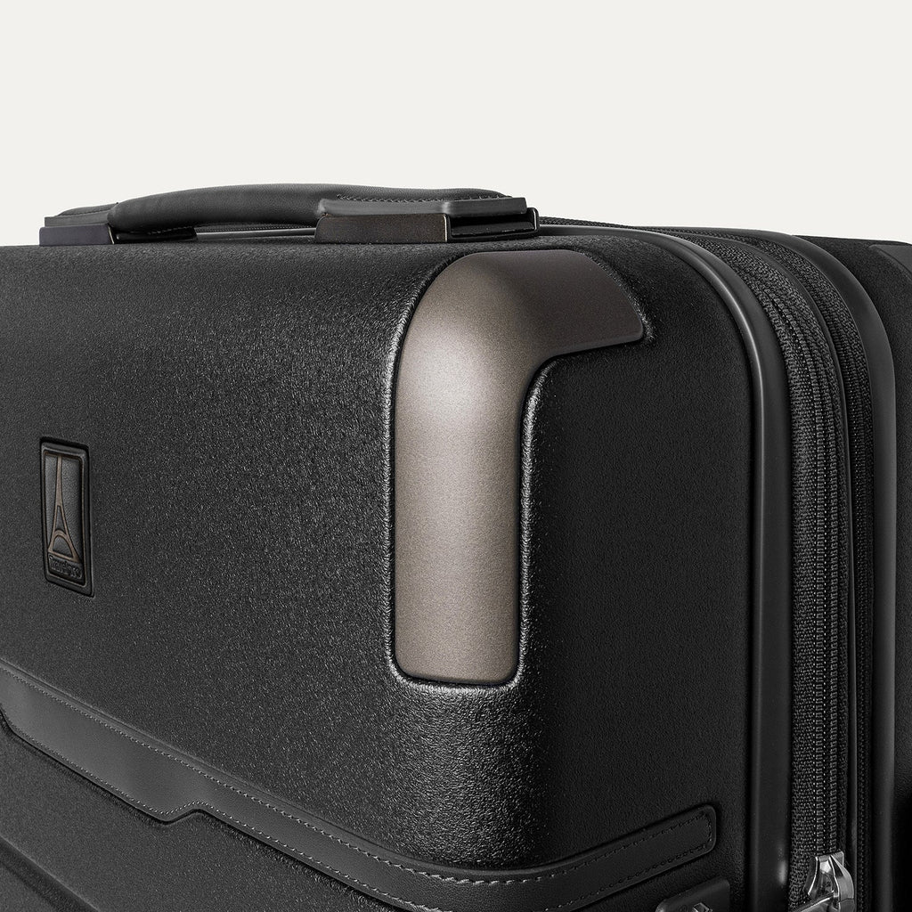Close-up of the zinc corner armour on the Travelpro Platinum Reserve Compact Cabin Hardshell Spinner in Black Dust