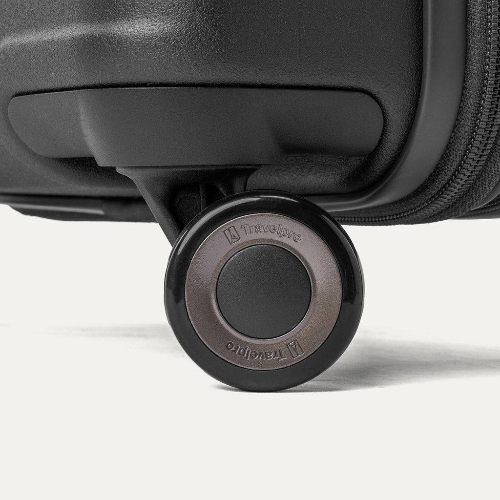 Close-up of a MagnaTrac self-aligning spinner wheel on the Travelpro Platinum Reserve Compact Cabin Hardshell Spinner in Black Dust