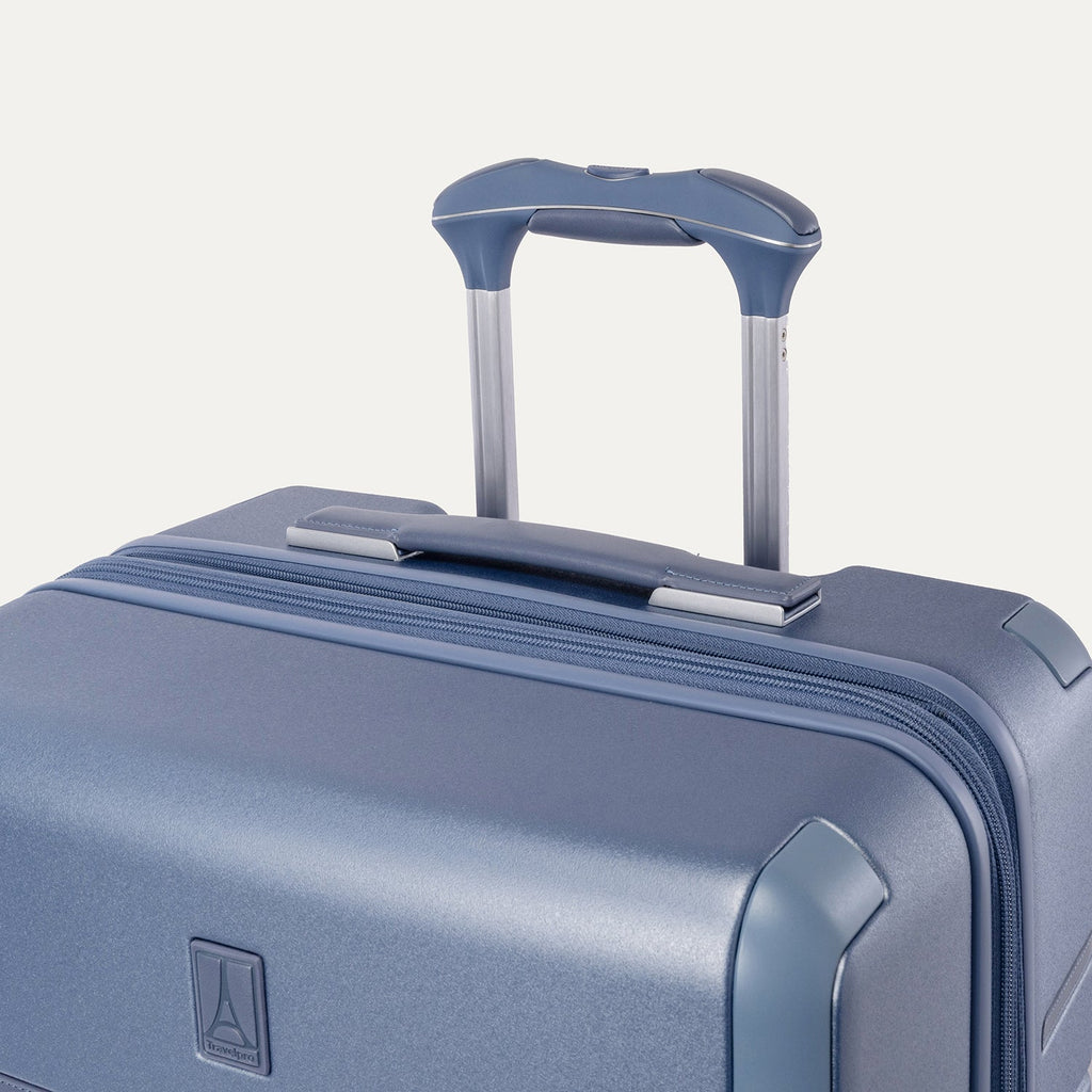 Close-up of the leather-wrapped top handle and PowerScope Lite extension handle on the Travelpro Platinum Reserve Compact Cabin Hardshell Spinner in Steel Blue