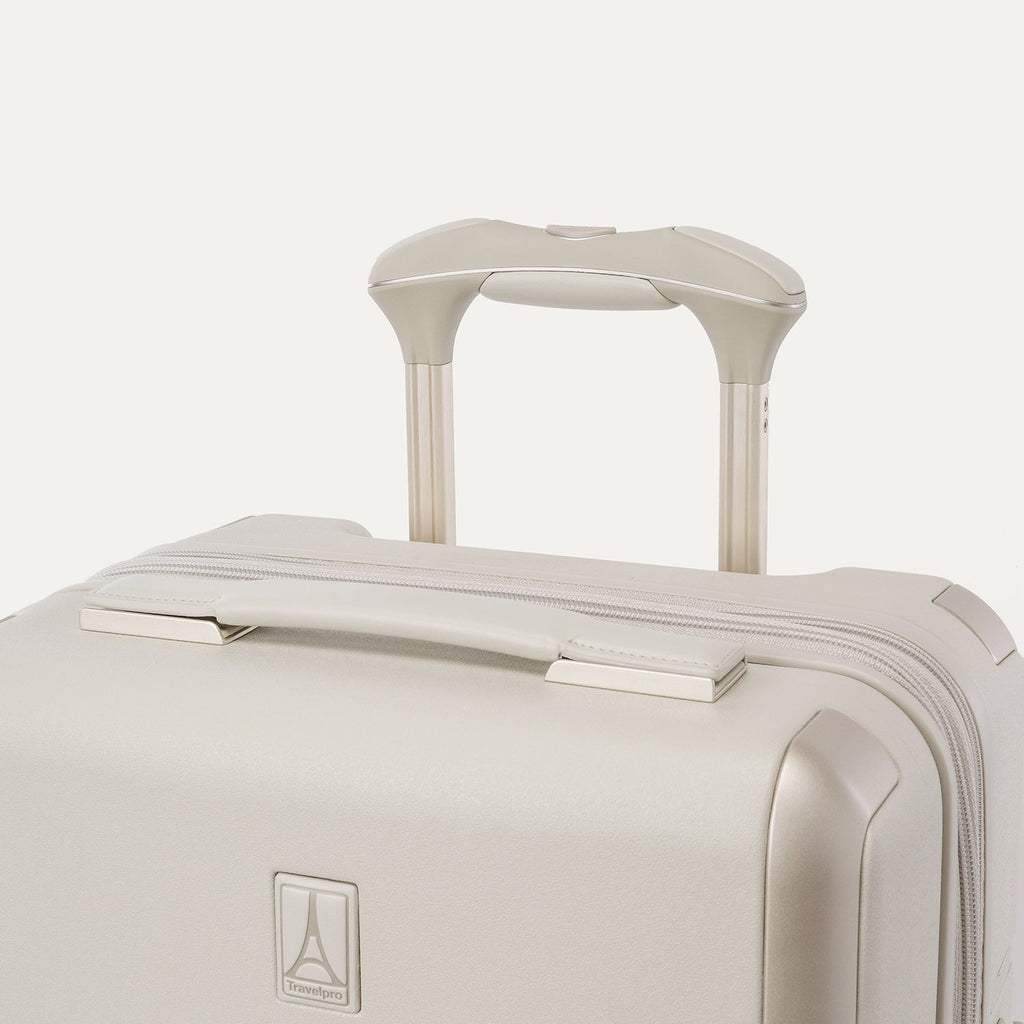 Close-up of the leather-wrapped top handle and PowerScope Lite extension handle on the Travelpro Platinum Reserve Compact Cabin Hardshell Spinner in Sandstone