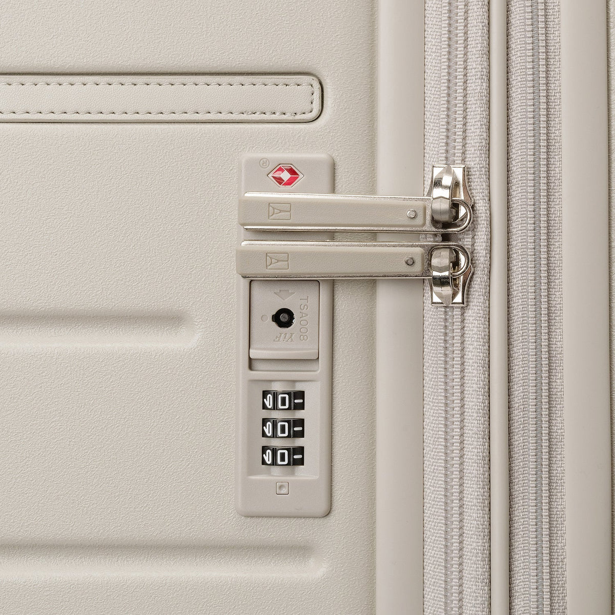 Close-up of the built-in TSA lock on the Travelpro Platinum Reserve Compact Cabin Hardshell Spinner in Sandstone