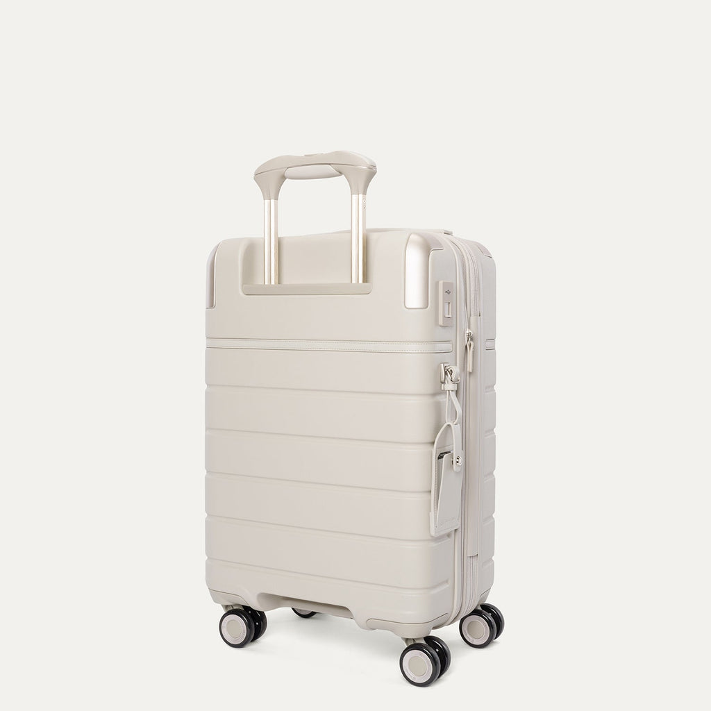 Rear angled view of the Travelpro Platinum Reserve Compact Cabin Hardshell Spinner in Sandstone