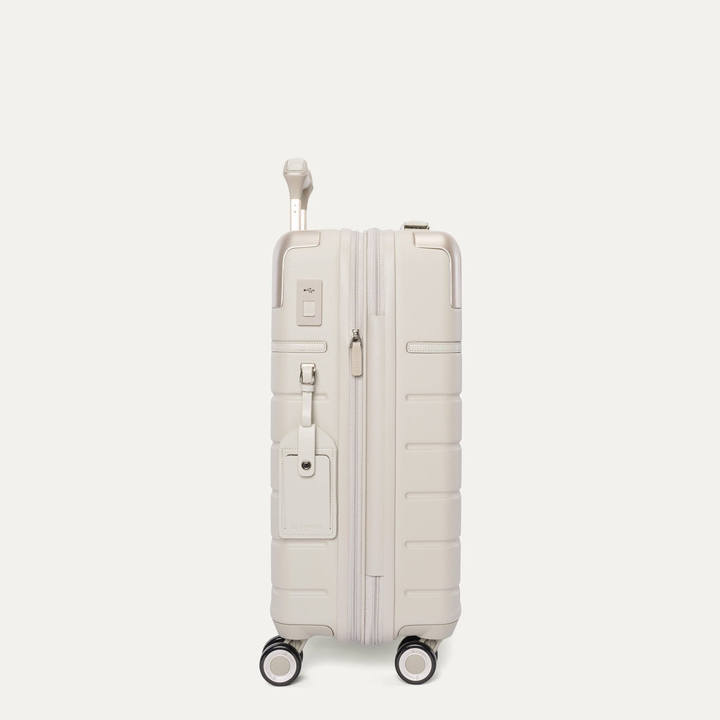 Side profile of the Travelpro Platinum Reserve Compact Cabin Hardshell Spinner in Sandstone