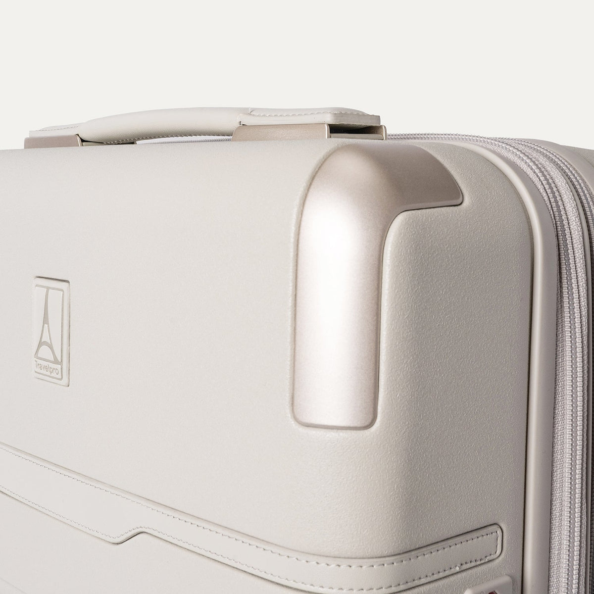 Close-up of the zinc corner armour on the Travelpro Platinum Reserve Compact Cabin Hardshell Spinner in Sandstone