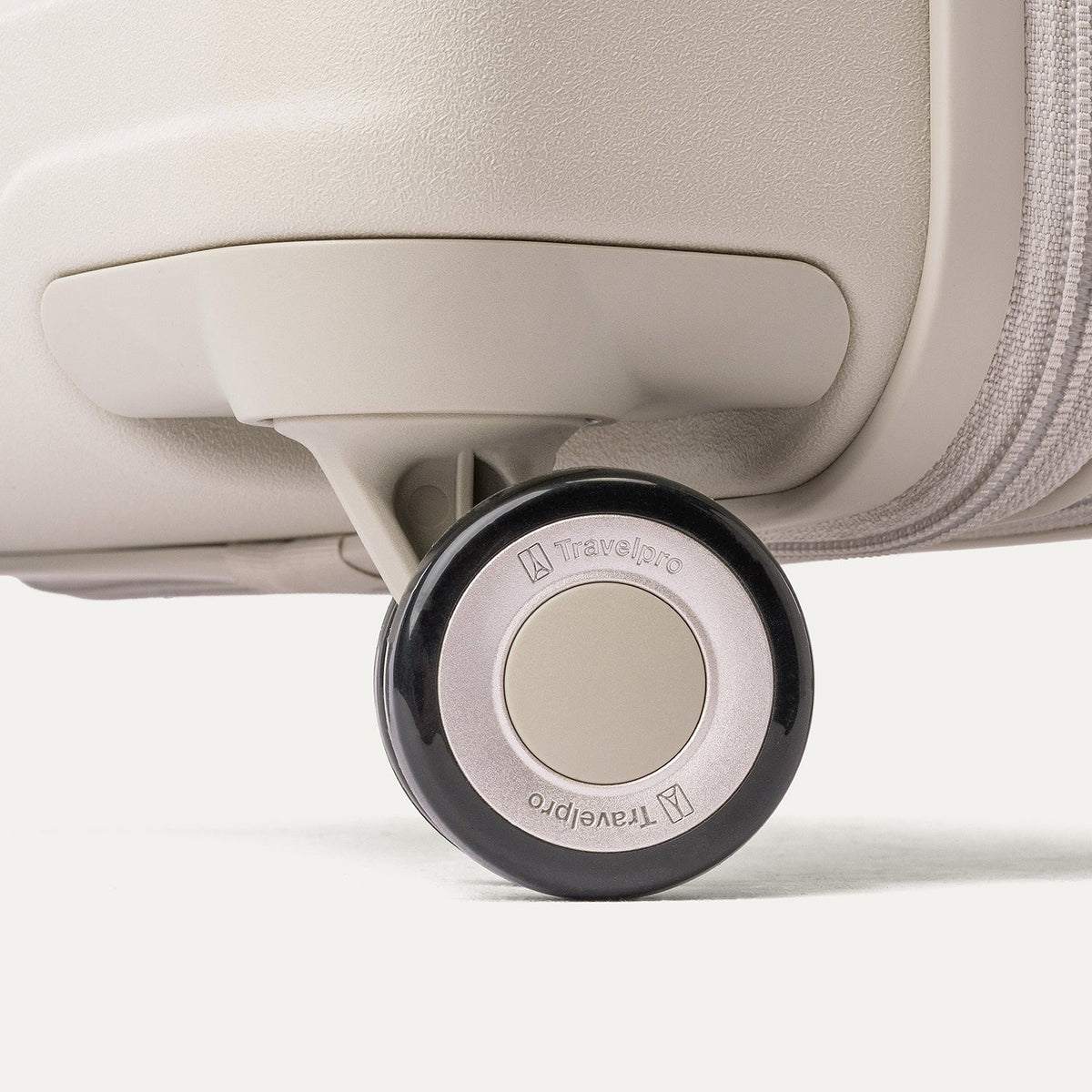 Close-up of a MagnaTrac self-aligning spinner wheel on the Travelpro Platinum Reserve Compact Cabin Hardshell Spinner in Sandstone