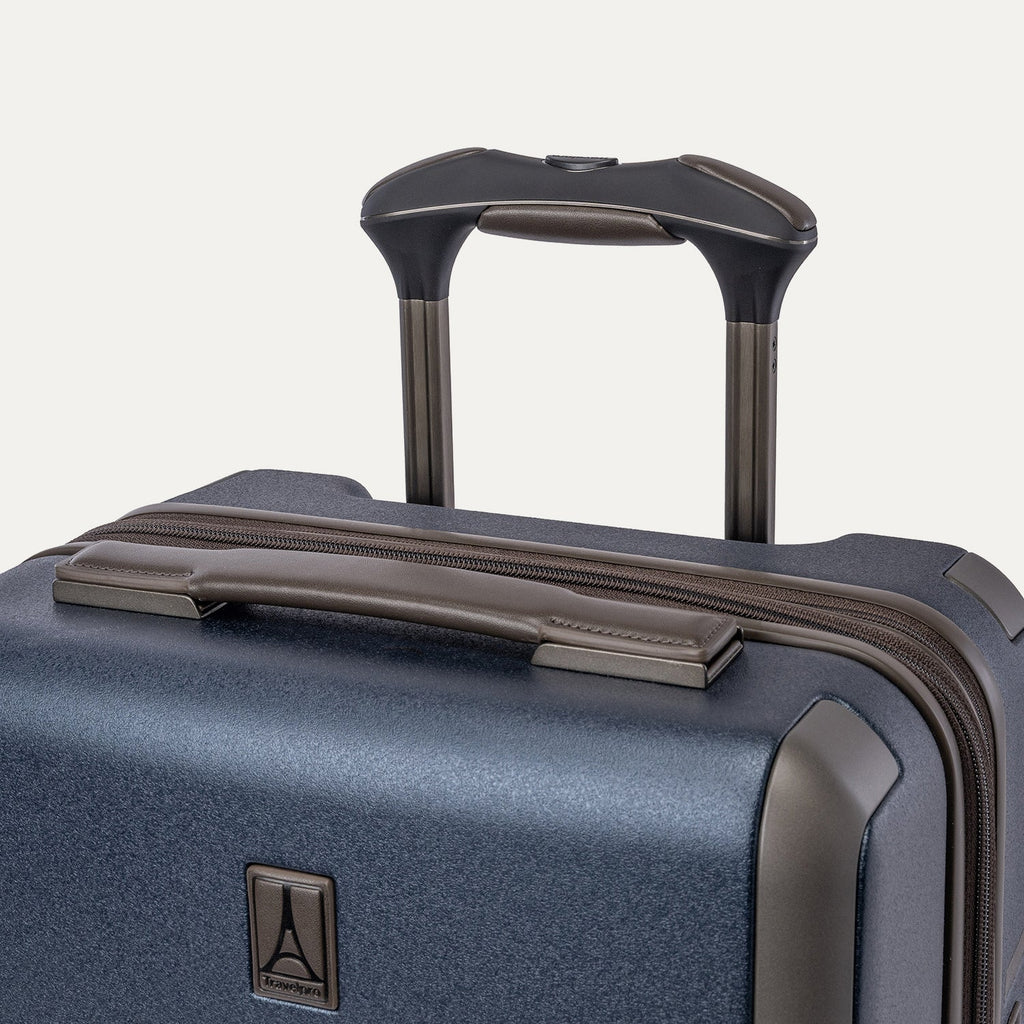 Close-up of the leather-wrapped top handle and PowerScope Lite extension handle on the Travelpro Platinum Reserve Compact Cabin Hardshell Spinner in Midnight Trail