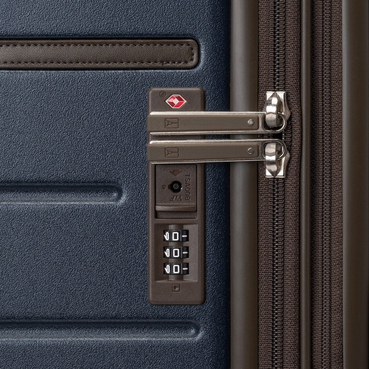 Close-up of the built-in TSA lock on the Travelpro Platinum Reserve Compact Cabin Hardshell Spinner in Midnight Trail