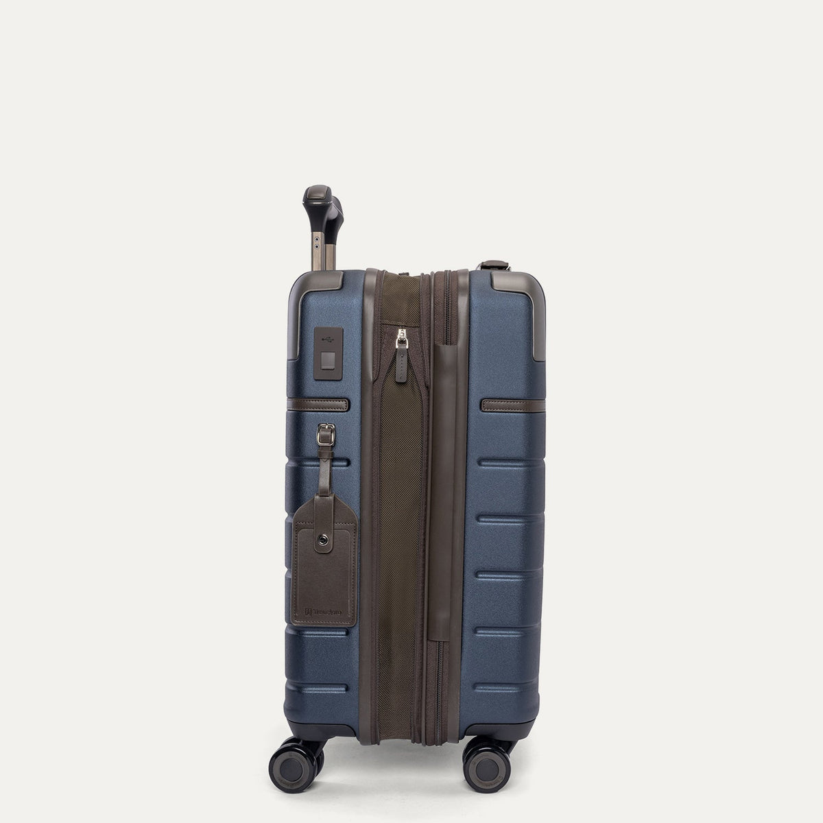 Side profile of the Travelpro Platinum Reserve Compact Cabin Hardshell Spinner in Midnight Trail, expanded for extra packing space