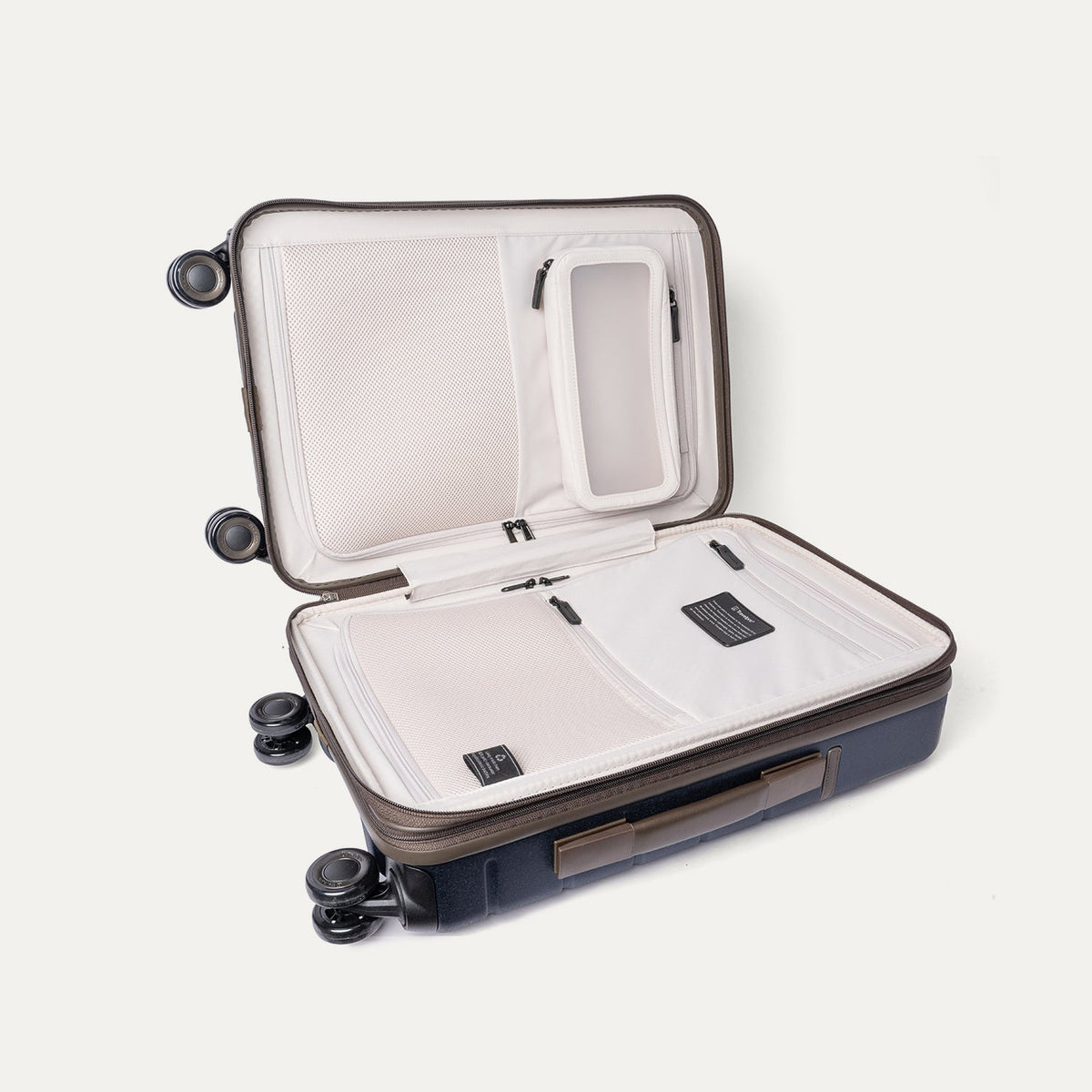 Open interior of the Travelpro Platinum Reserve Compact Cabin Hardshell Spinner in Midnight Trail showing the zippered divider panel and dedicated pockets