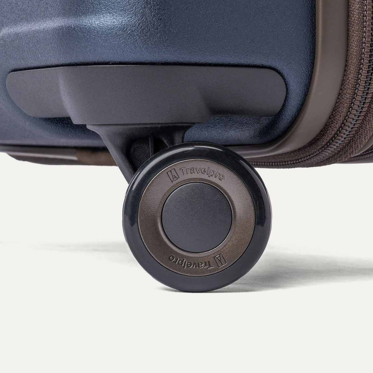 Close-up of a MagnaTrac self-aligning spinner wheel on the Travelpro Platinum Reserve Compact Cabin Hardshell Spinner in Midnight Trail