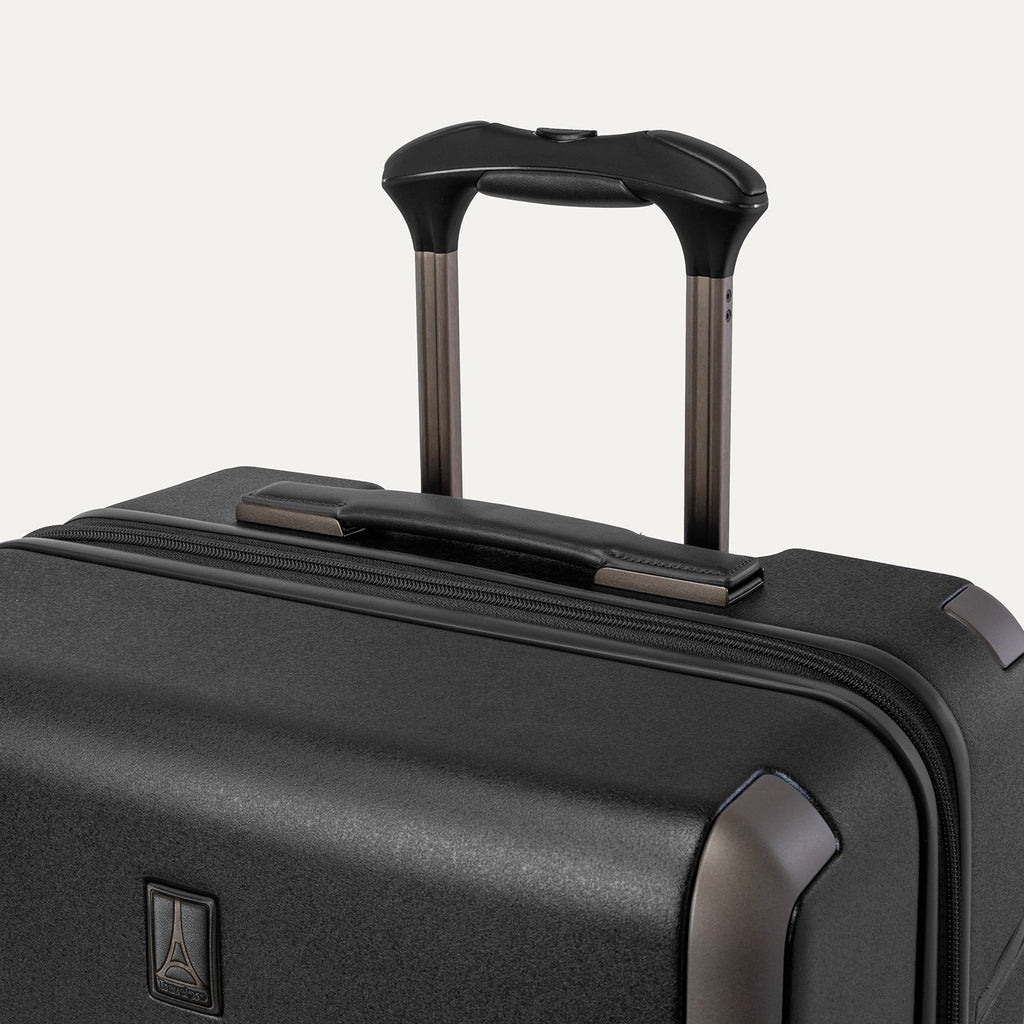Close-up of the leather-wrapped top handle and PowerScope Lite extension handle on the Travelpro Platinum Reserve Medium Check-In Hardshell Spinner in Black Dust