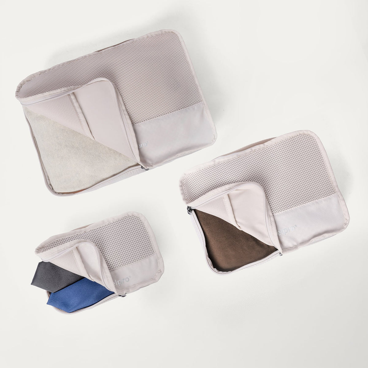 Packing cubes included with the Travelpro Platinum Reserve Medium Check-In Hardshell Spinner in Black Dust, shown open with folded clothing