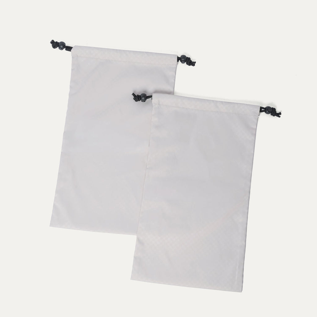Removable drawstring shoe bags included with the Travelpro Platinum Reserve Medium Check-In Hardshell Spinner in Black Dust
