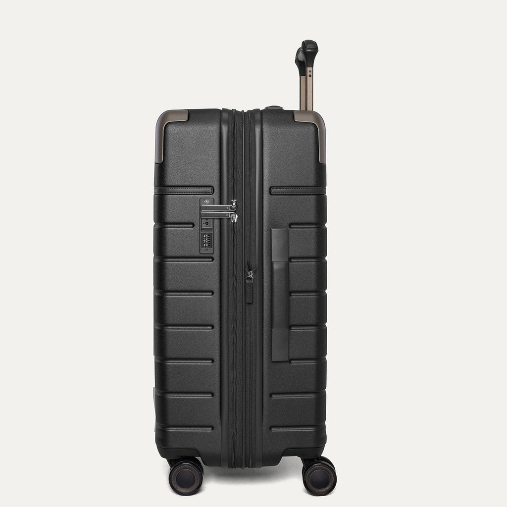 Side profile of the Travelpro Platinum Reserve Medium Check-In Hardshell Spinner in Black Dust