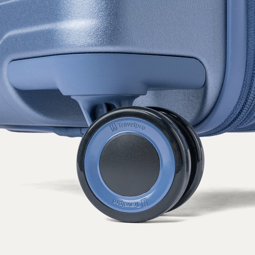 Close-up of a MagnaTrac self-aligning spinner wheel on the Travelpro Platinum Reserve Medium Check-In Hardshell Spinner in Steel Blue