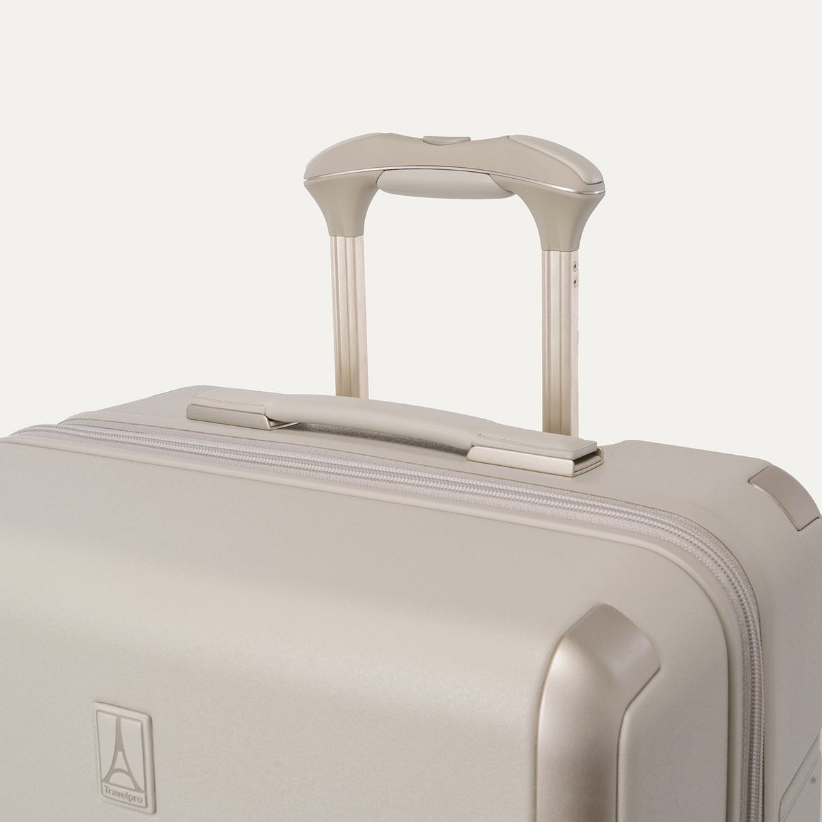 Close-up of the leather-wrapped top handle and PowerScope Lite extension handle on the Travelpro Platinum Reserve Medium Check-In Hardshell Spinner in Sandstone