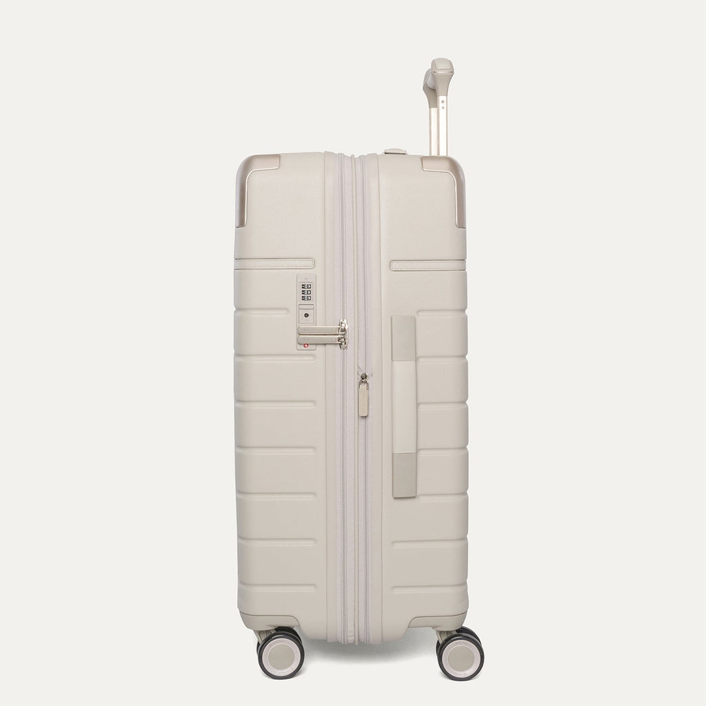 Side profile of the Travelpro Platinum Reserve Medium Check-In Hardshell Spinner in Sandstone