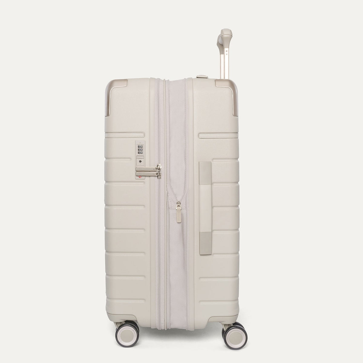 Side profile of the Travelpro Platinum Reserve Medium Check-In Hardshell Spinner in Sandstone, expanded for extra packing space