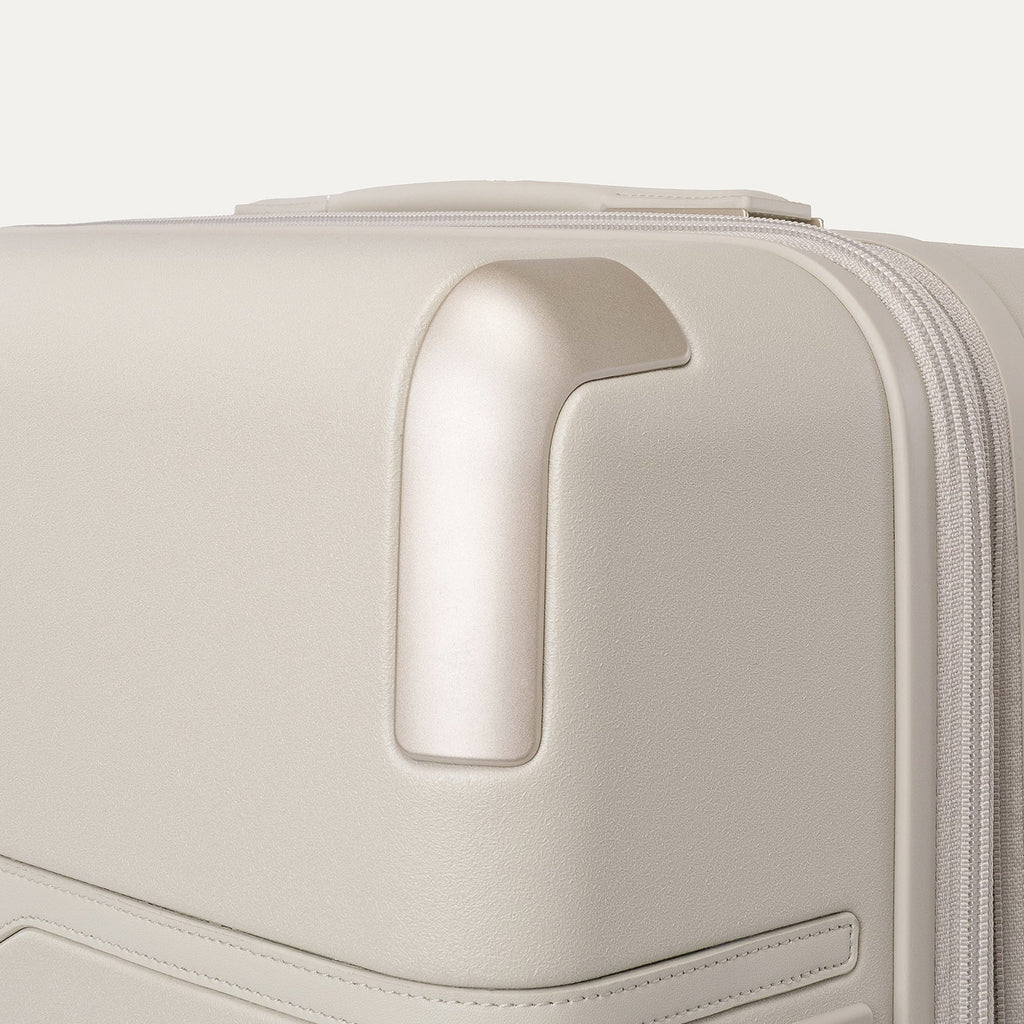 Close-up of the zinc corner armour on the Travelpro Platinum Reserve Medium Check-In Hardshell Spinner in Sandstone