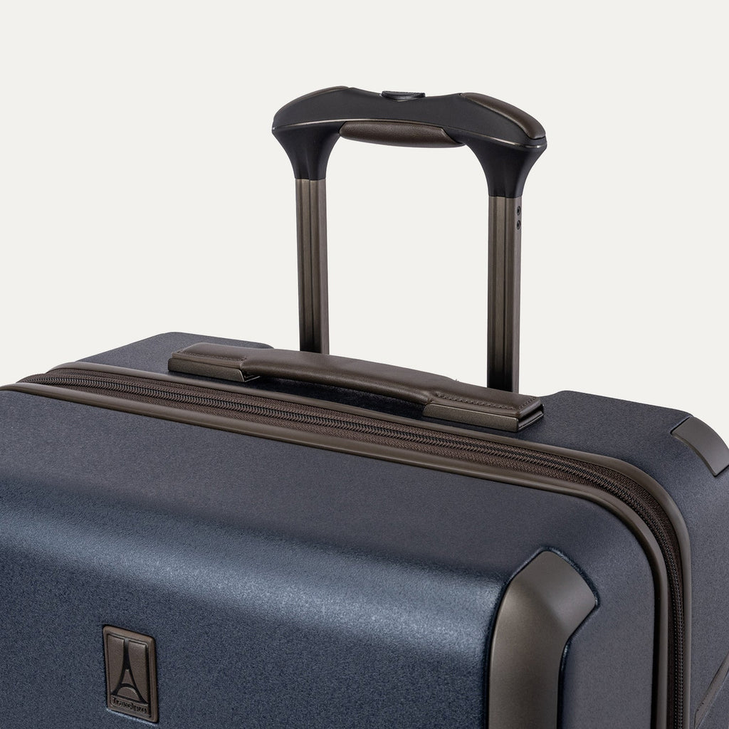 Close-up of the leather-wrapped top handle and PowerScope Lite extension handle on the Travelpro Platinum Reserve Medium Check-In Hardshell Spinner in Midnight Trail