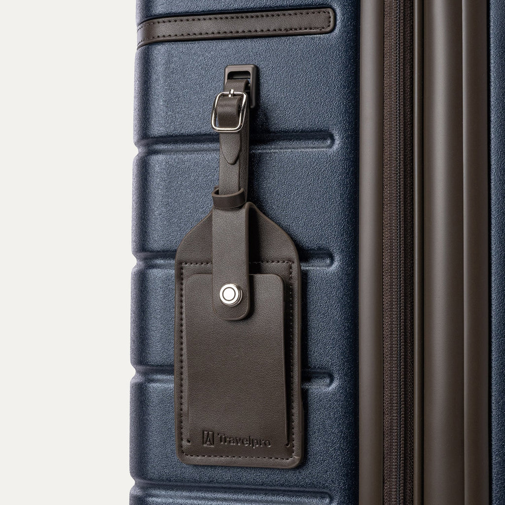 Close-up of the full-grain leather luggage tag on the Travelpro Platinum Reserve Medium Check-In Hardshell Spinner in Midnight Trail