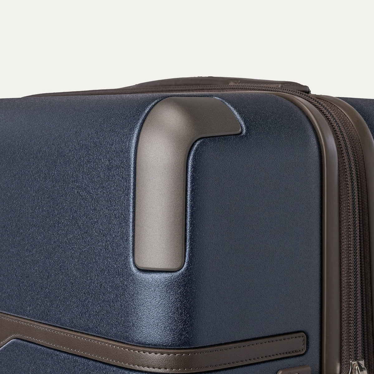 Close-up of the zinc corner armour on the Travelpro Platinum Reserve Medium Check-In Hardshell Spinner in Midnight Trail