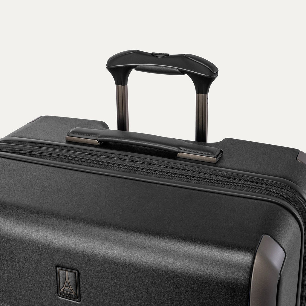 Close-up of the leather-wrapped top handle and PowerScope Lite extension handle on the Travelpro Platinum Reserve Large Check-In Hardshell Spinner in Black Dust