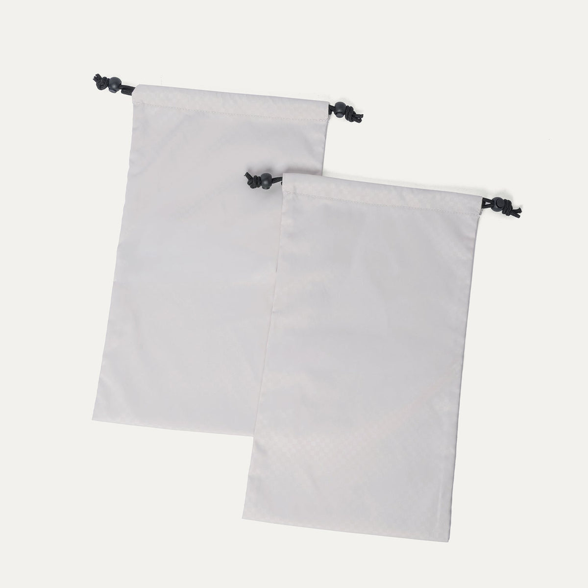 Removable drawstring shoe bags included with the Travelpro Platinum Reserve Large Check-In Hardshell Spinner in Black Dust