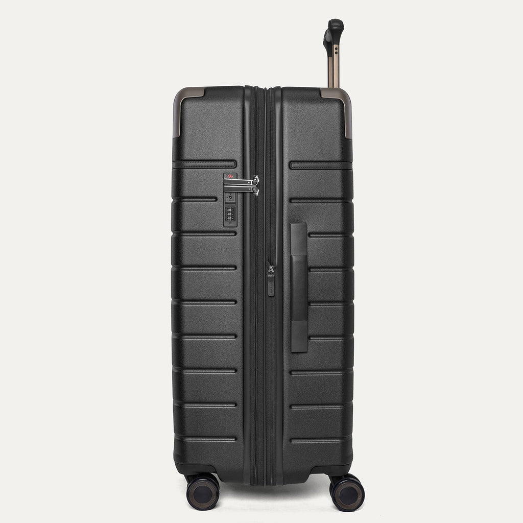 Side profile of the Travelpro Platinum Reserve Large Check-In Hardshell Spinner in Black Dust