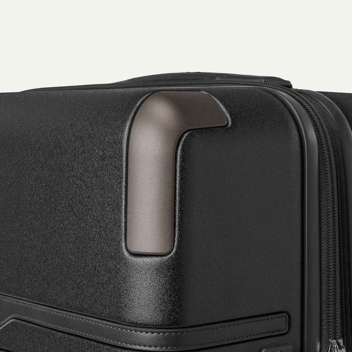 Close-up of the zinc corner armour on the Travelpro Platinum Reserve Large Check-In Hardshell Spinner in Black Dust