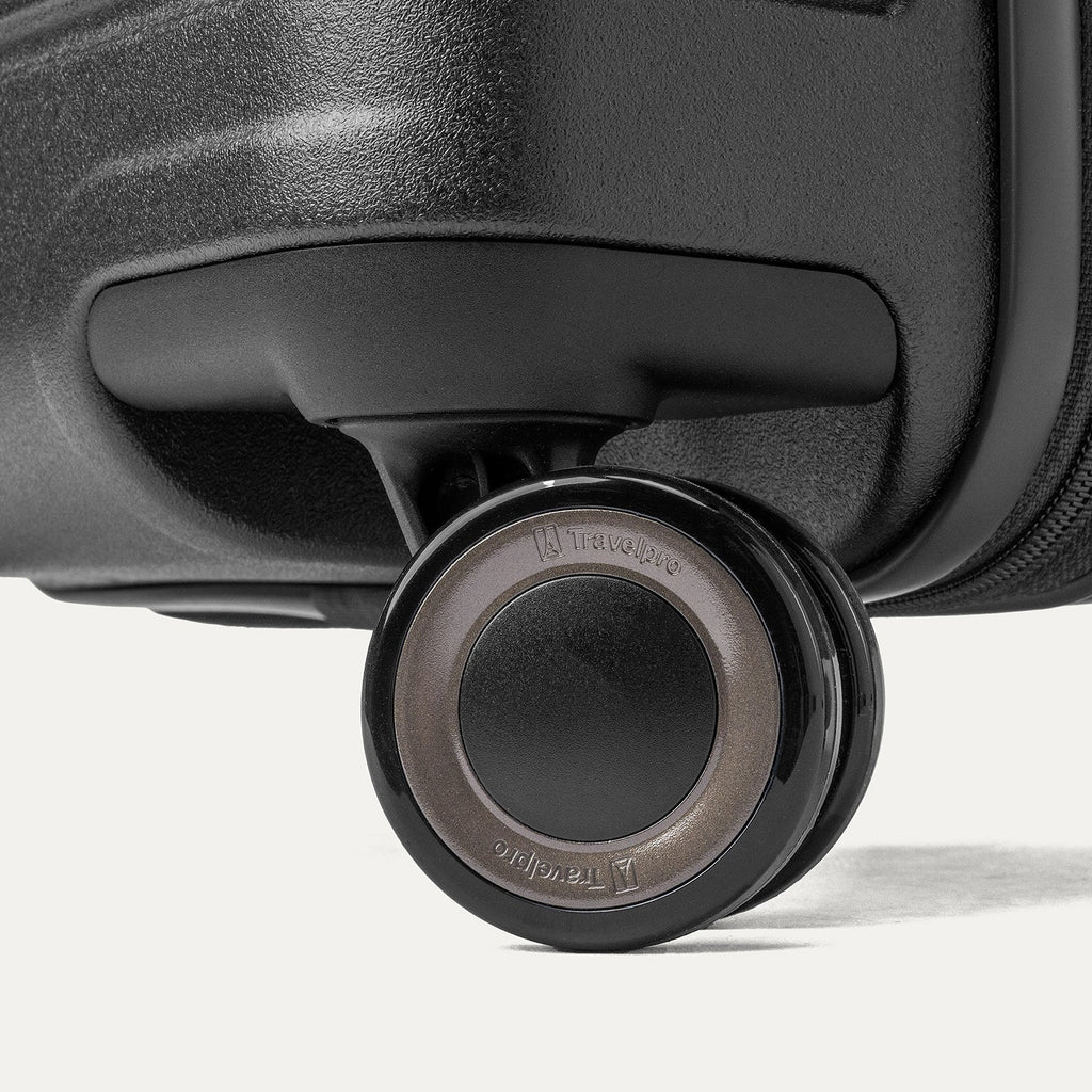Close-up of a MagnaTrac self-aligning spinner wheel on the Travelpro Platinum Reserve Large Check-In Hardshell Spinner in Black Dust