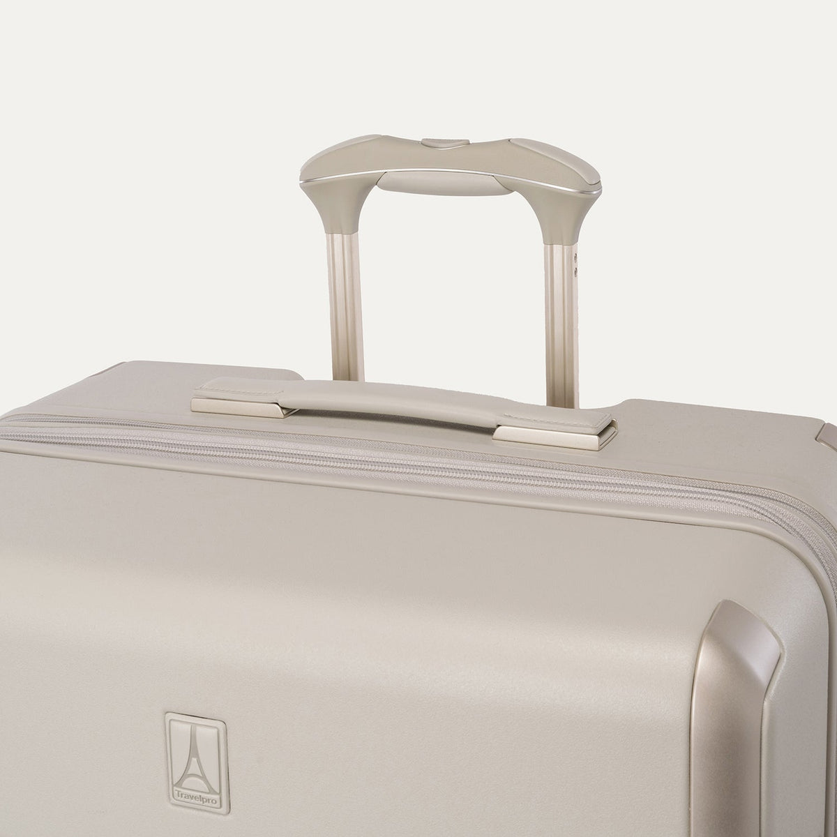 Close-up of the leather-wrapped top handle and PowerScope Lite extension handle on the Travelpro Platinum Reserve Large Check-In Hardshell Spinner in Sandstone