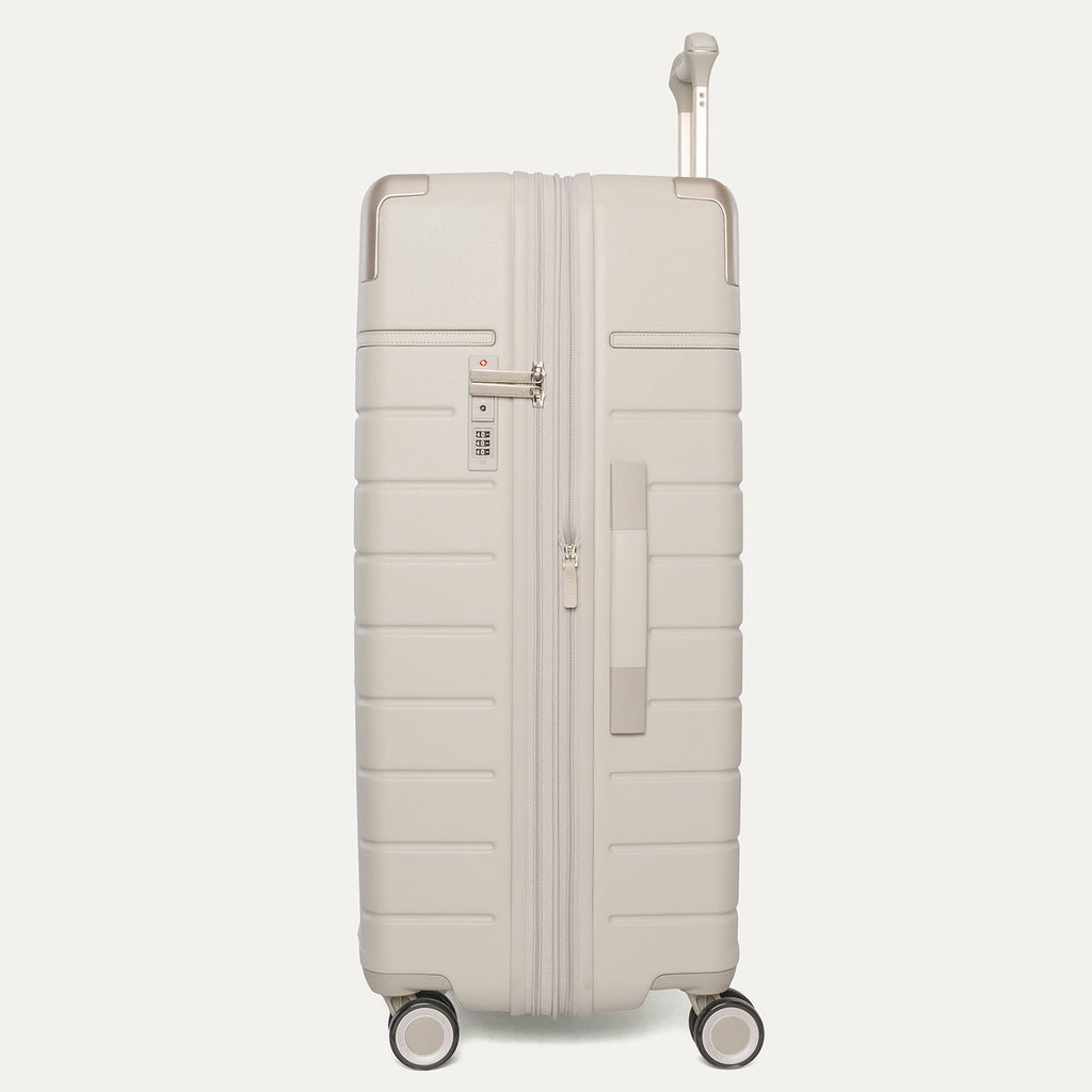 Side profile of the Travelpro Platinum Reserve Large Check-In Hardshell Spinner in Sandstone