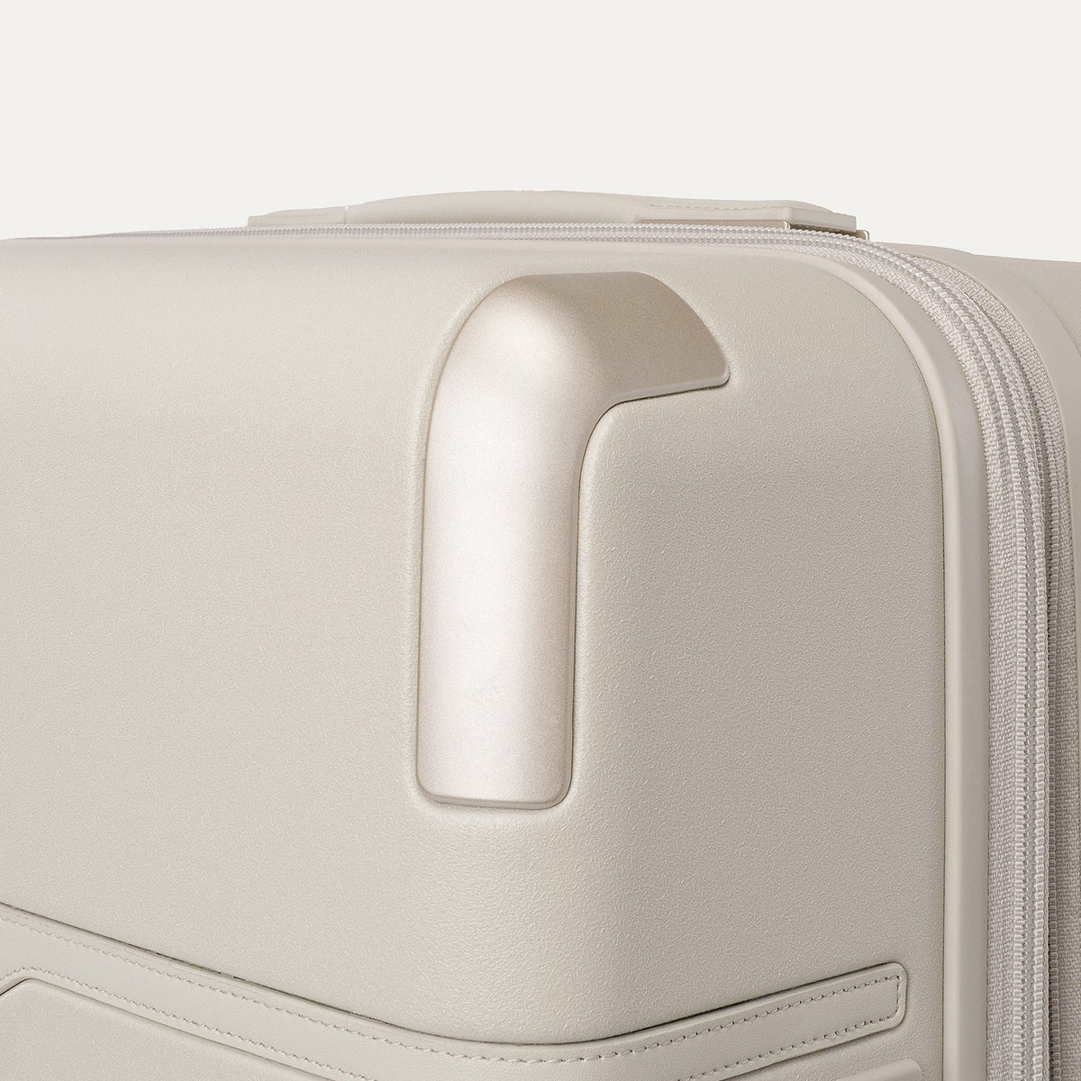 Close-up of the zinc corner armour on the Travelpro Platinum Reserve Large Check-In Hardshell Spinner in Sandstone