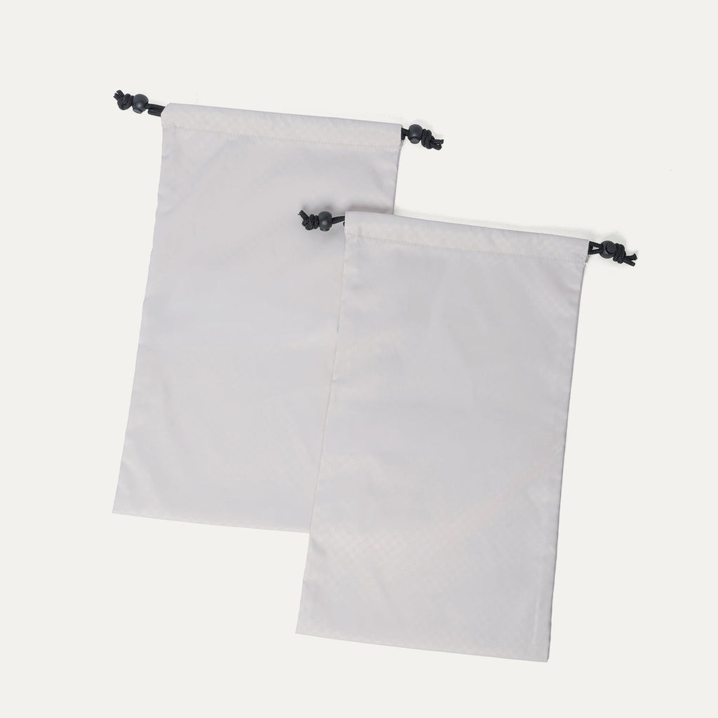 Removable drawstring shoe bags included with the Travelpro Platinum Reserve Large Check-In Hardshell Spinner in Midnight Trail