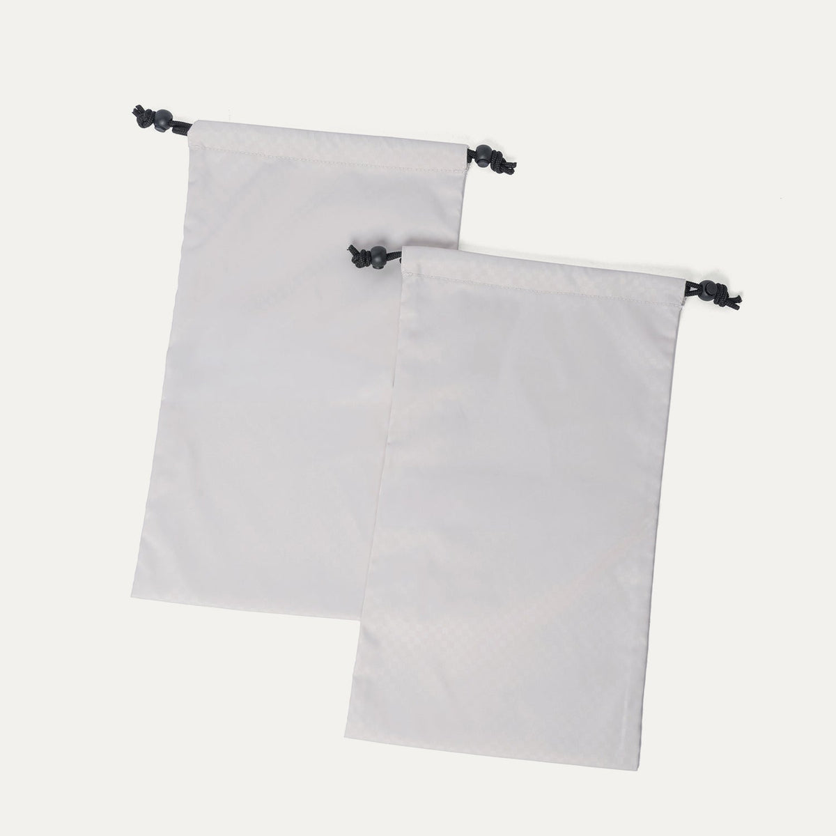 Removable drawstring shoe bags included with the Travelpro Platinum Reserve Large Check-In Hardshell Spinner in Midnight Trail