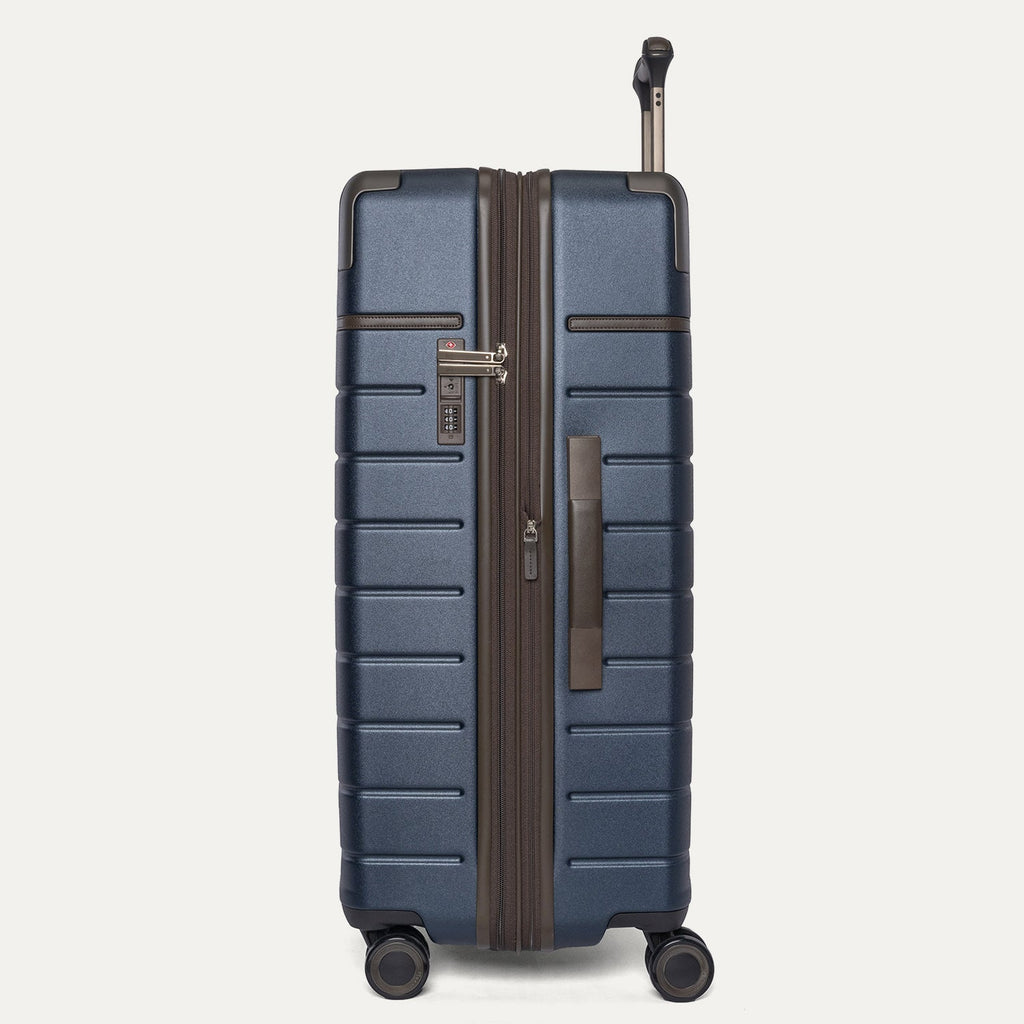 Side profile of the Travelpro Platinum Reserve Large Check-In Hardshell Spinner in Midnight Trail