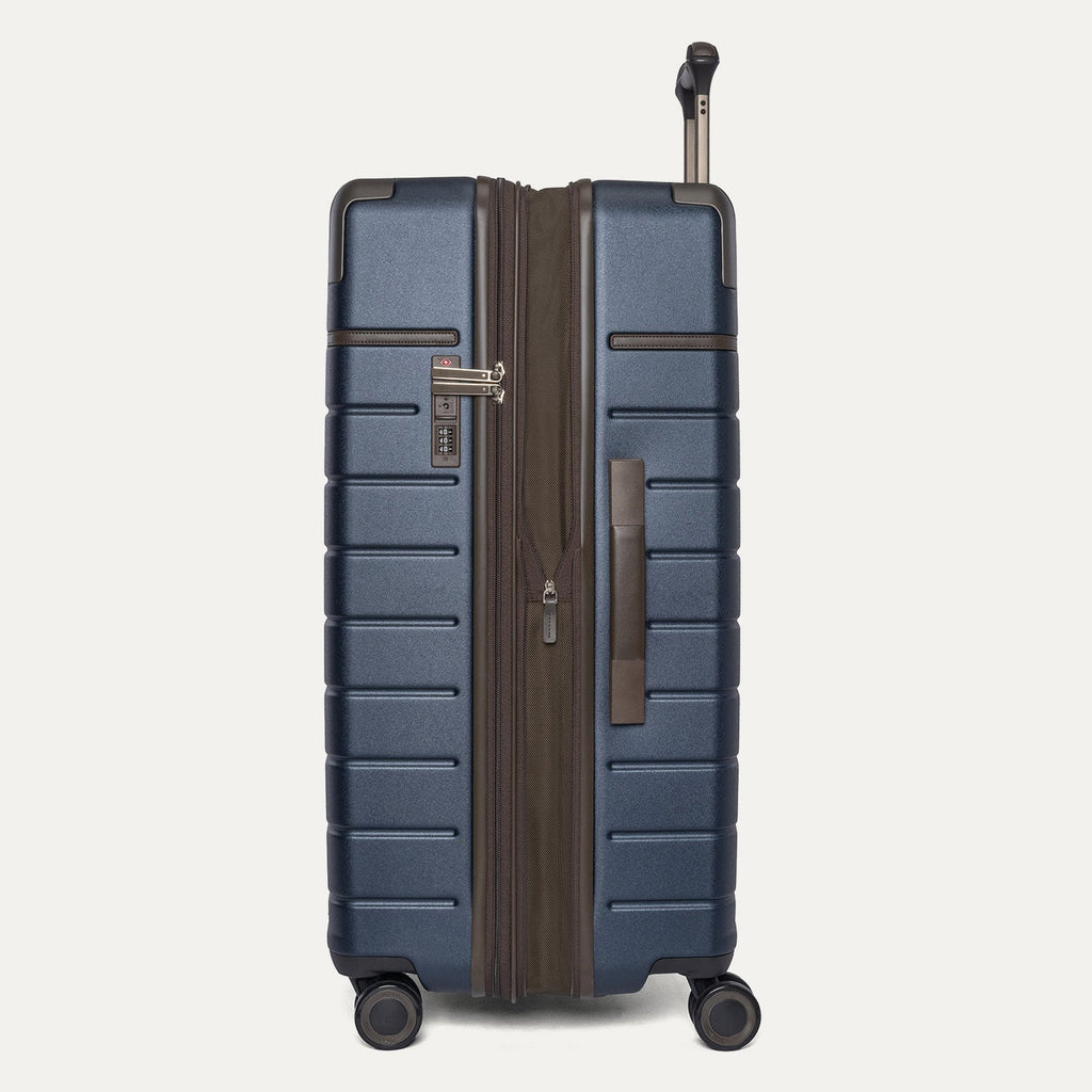 Side profile of the Travelpro Platinum Reserve Large Check-In Hardshell Spinner in Midnight Trail, expanded for extra packing space