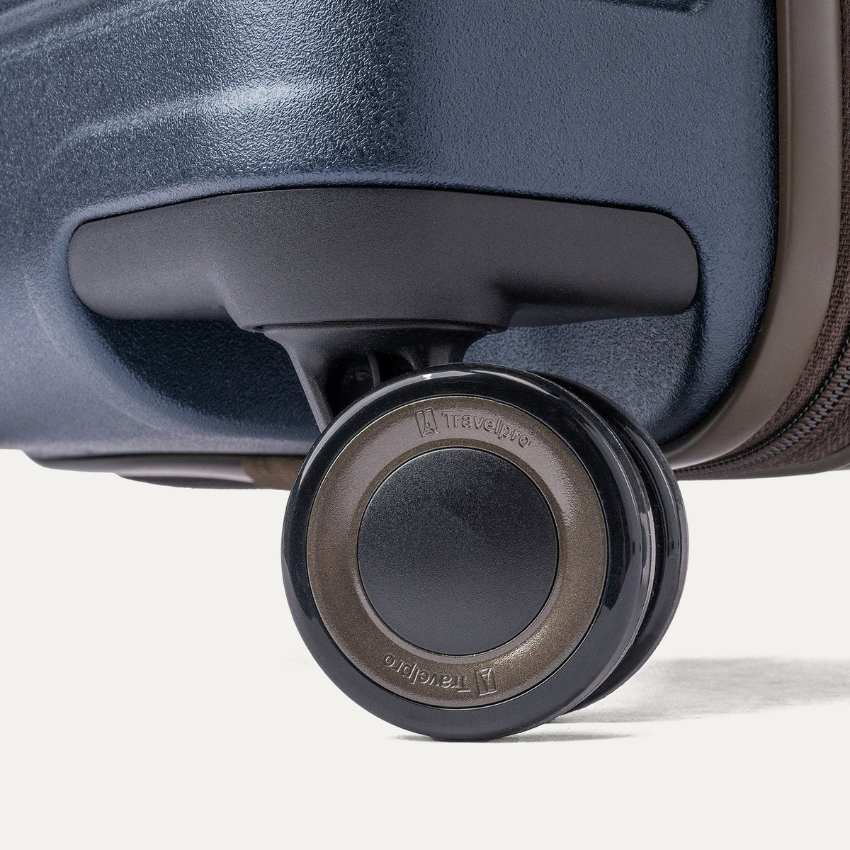 Close-up of a MagnaTrac self-aligning spinner wheel on the Travelpro Platinum Reserve Large Check-In Hardshell Spinner in Midnight Trail