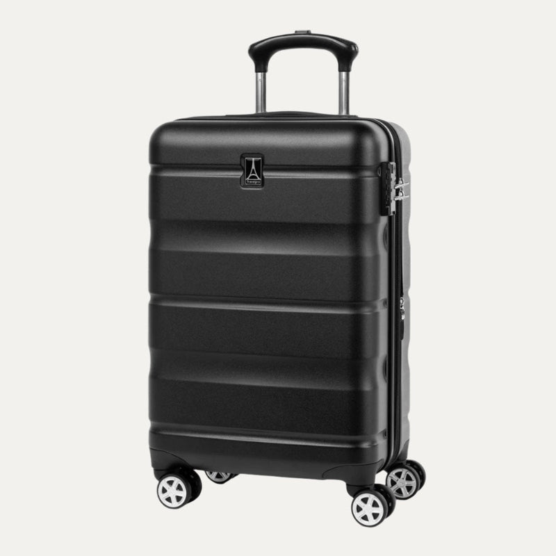 Black hardside spinner suitcase in a slanted front view with extended telescopic handle and four dual wheels.
